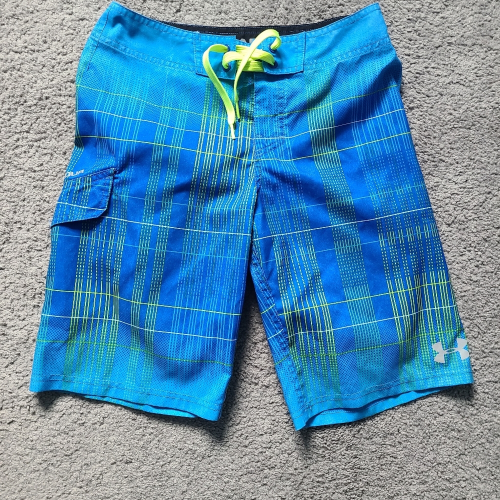 Boy's Under Armour board shorts, blue and with neon yellow stripes.